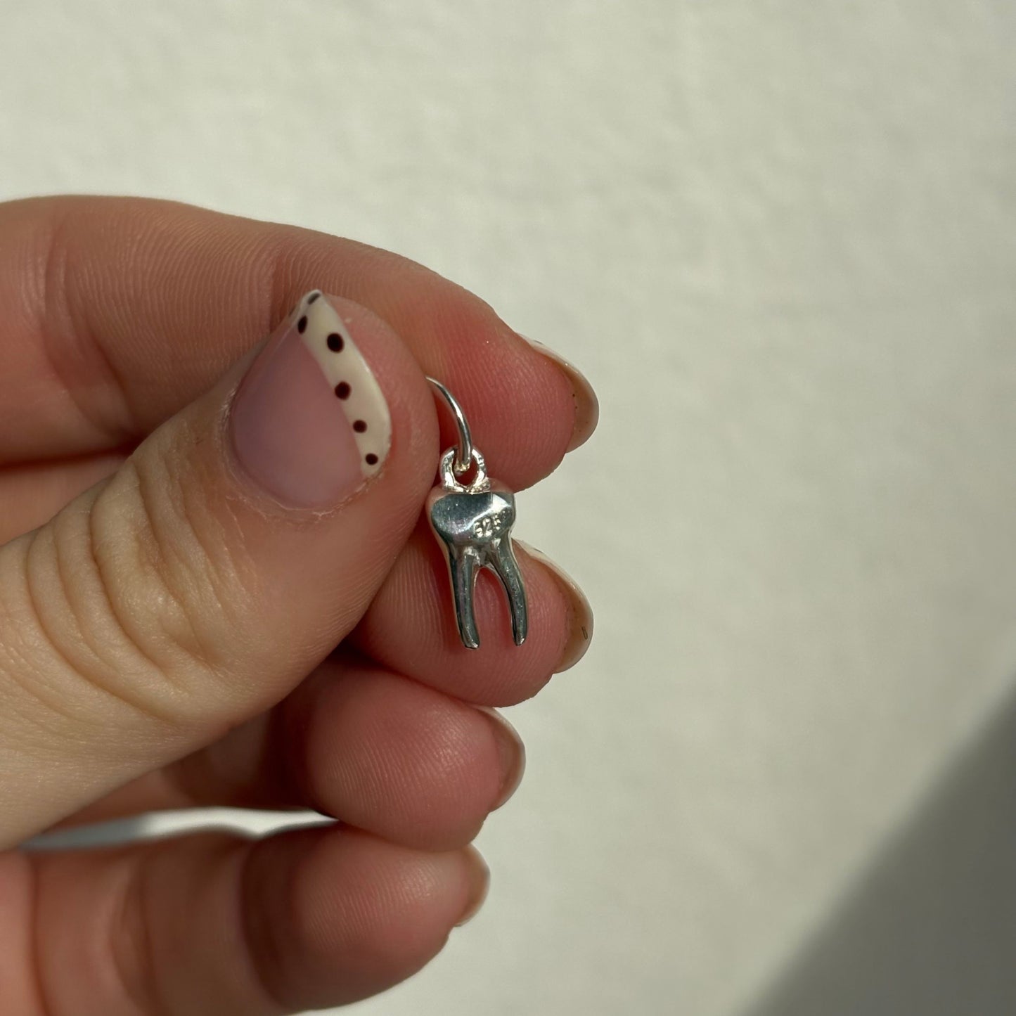 silver baby tooth charm