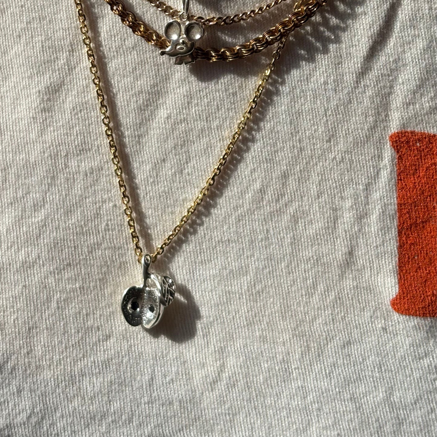 silver big apple with black diamond seeds charm