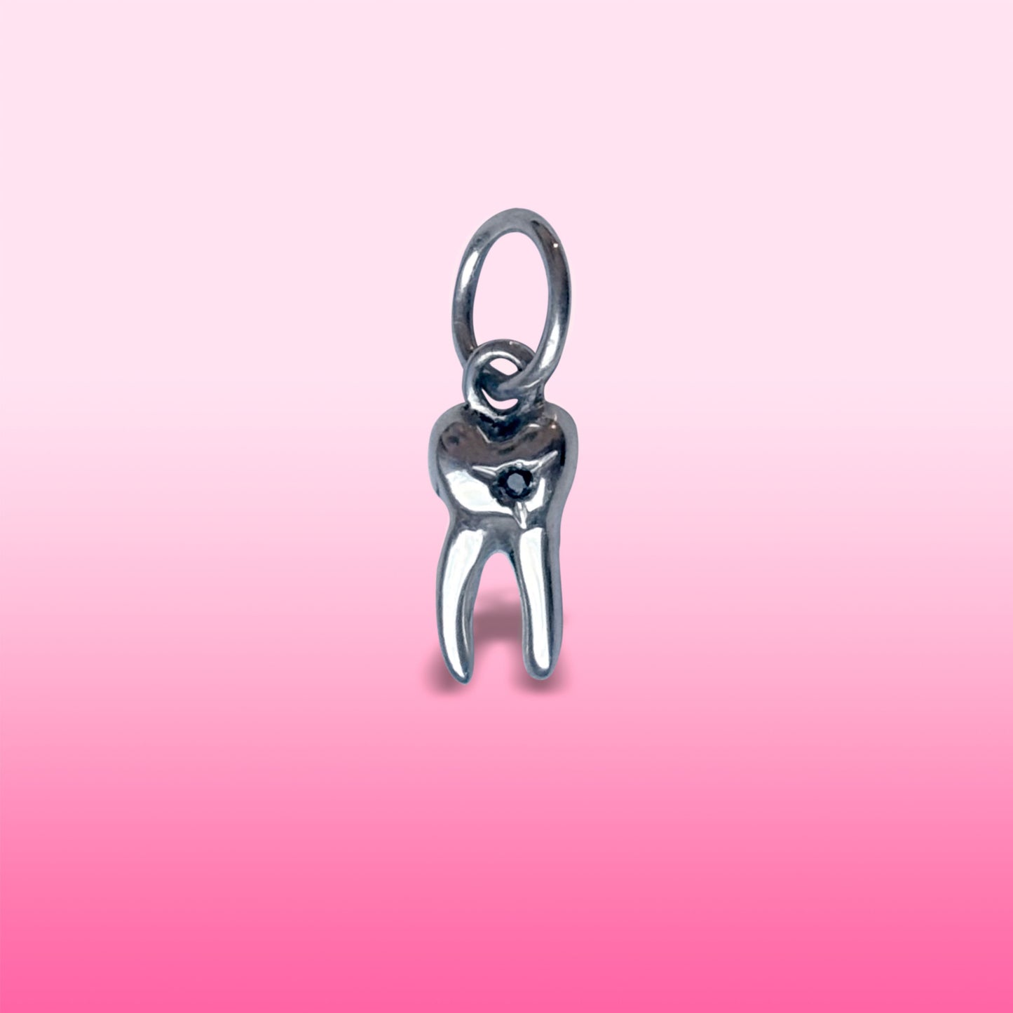 silver baby tooth with star set black diamond charm