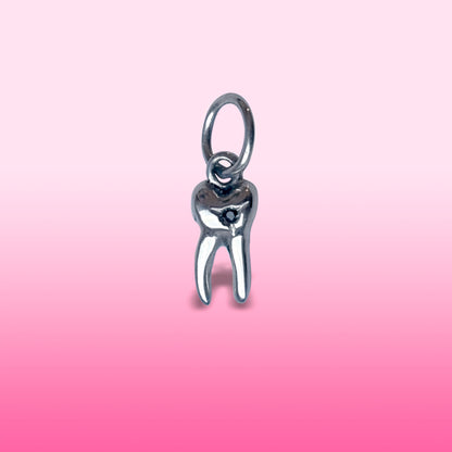 silver baby tooth with star set black diamond charm