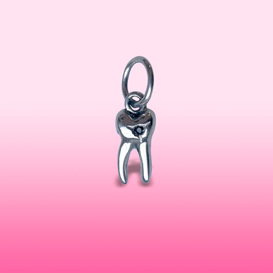 silver baby tooth with star set black diamond charm