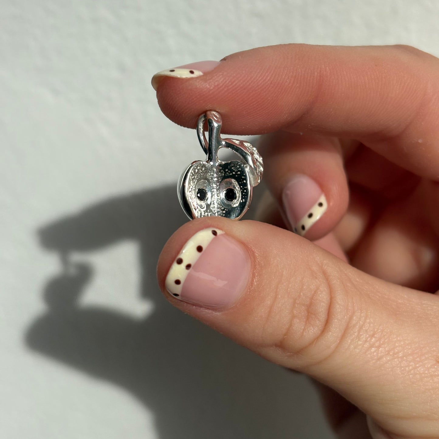 silver big apple with black diamond seeds charm