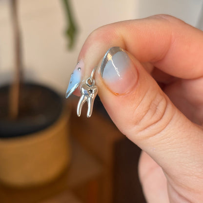 silver baby tooth with star set black diamond charm