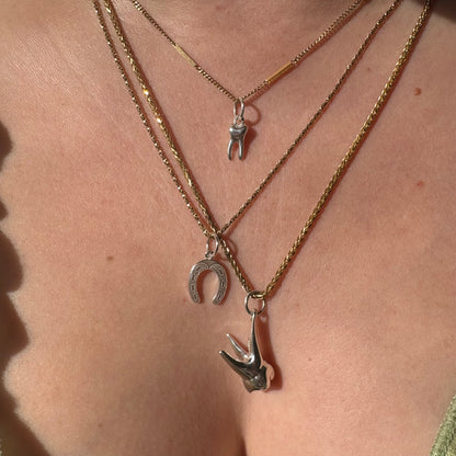 silver baby tooth charm