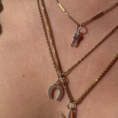 silver baby tooth charm