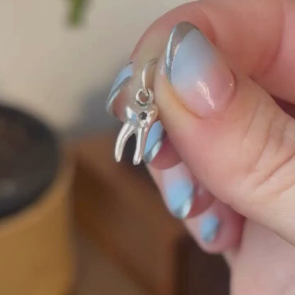 silver baby tooth with star set black diamond charm