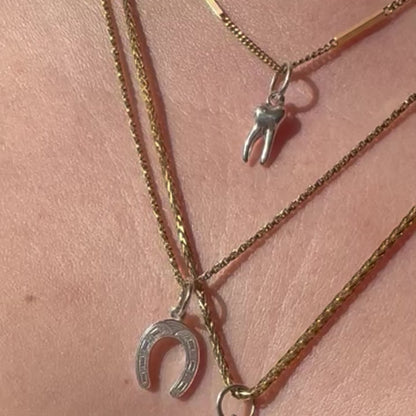 silver baby tooth charm